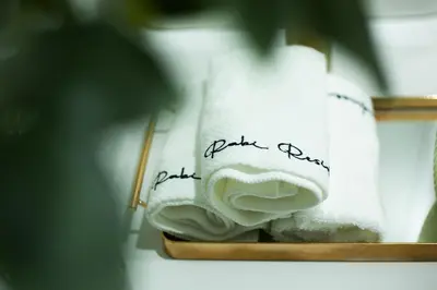 a pile of towels on a shelf with writing on it at French Unit - 1st floor sleeps 2 in Arusha