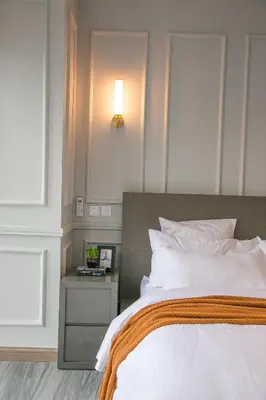 a bedroom with a bed and a nightstand next to a bed sidx sidx sidx at French Unit - 1st floor sleeps 2 in Arusha