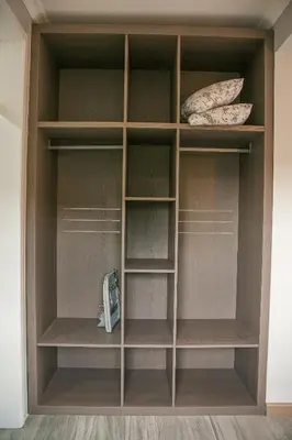 a closet with wooden shelves and a toaster at Rabi Residence - Two French units sleeps 4 in Arusha