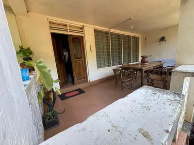 a room with a table and chairs and a dining room at Kwetu Homestay Spacious 4BR Home in Moshi