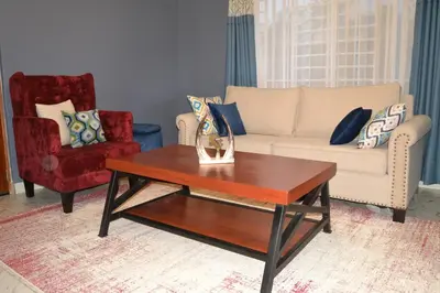 a living room with a couch and a coffee table at Molly's Cozy Place in Arusha