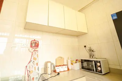 a kitchen with a counter top with a microwave at Cozy Urban home in Arusha