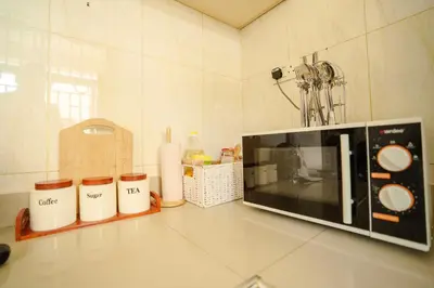 a microwave on a counter in a kitchen at Cozy Urban home in Arusha
