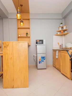 a kitchen with a refrigerator and a counter top at River point inn in Arusha