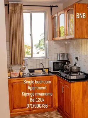 a kitchen with a sink and a stove and a window at River point inn in Arusha