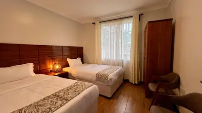 a hotel room with two beds and a window at Iwandaa Apartments in Nkoanrua