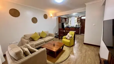 a living room with a couch and a table at Iwandaa Apartments in Nkoanrua