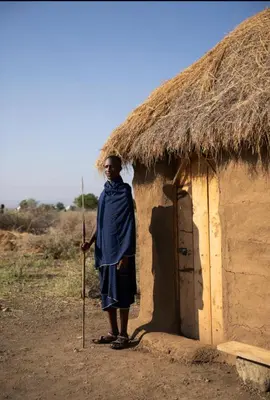 a man standing in front of a hut at Ewang'ani Maasai Cultural Village - Overnight Experience and Tour in Sanya Chini Station