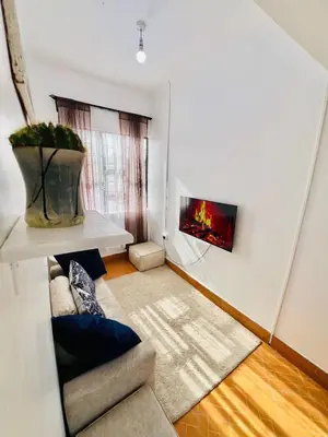 a living room with a couch and a window at Oshey Home Stay in Arusha