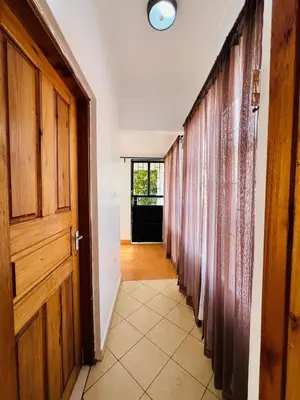 an empty hallway with curtains and a door at Oshey Home Stay in Arusha