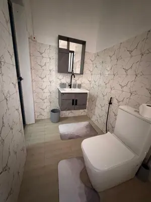 a bathroom with a toilet and a sink and a mirror at Afrika Royal Safari in Arusha