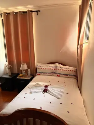 a bedroom with a bed with a bow on it at Afrika Royal Safari in Arusha