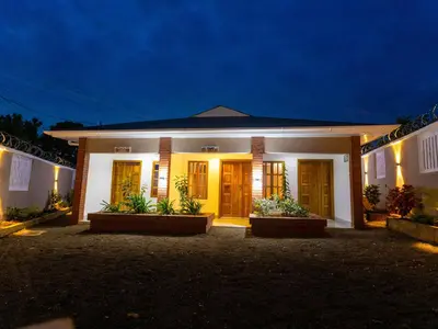 a house with a lit up facade at night at Msafiri Haven in Moshi