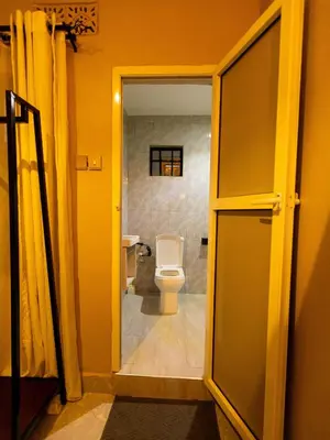 an open door to a bathroom with a toilet at Msafiri Haven in Moshi