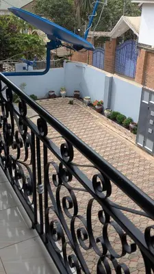 a black wrought iron fence with a brick patio at AvocadoAirbnb in Arusha