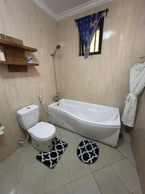 a bathroom with a tub and a toilet and a sink at Royal Afrika Safari in Arusha