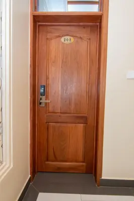 a wooden door in a hallway at Kilimont Hotel