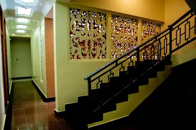 a staircase in a building with art on the wall at Kilimont Hotel