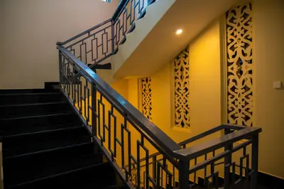 a set of stairs in a building with yellow walls at Kilimont Hotel