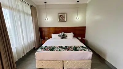 a bedroom with a large bed in a room at Iwandaa Lodge in Nkoanrua