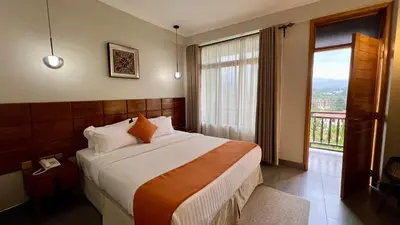 a bedroom with a large bed and a large window at Iwandaa Lodge in Nkoanrua