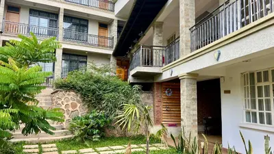 an apartment building with balconies and a courtyard at Iwandaa Lodge in Nkoanrua