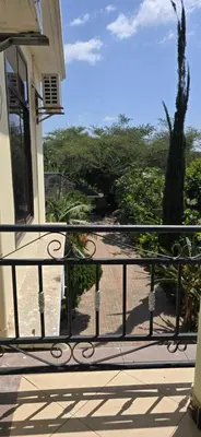 a balcony with a view of a yard at Greenhome apartment in Poli