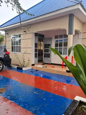 a house painted with blue and red paint at Kilimanjaro View Retreat in Moshi