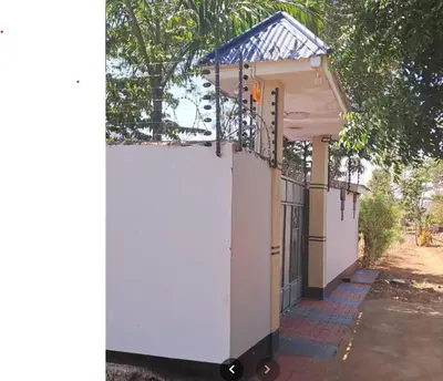 a small white building with a gate and a fence at Kilimanjaro View Retreat in Moshi