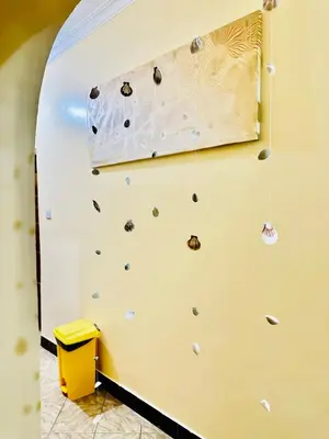 a climbing wall in a gym with a rock wall at Cozy 1Bedroom Stand Alone -Near Clock Tower Arusha in Arusha