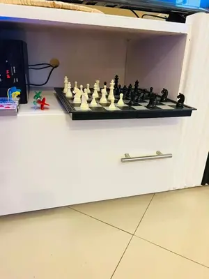 a chess board on top of a white cabinet at Cozy 1Bedroom Stand Alone -Near Clock Tower Arusha in Arusha