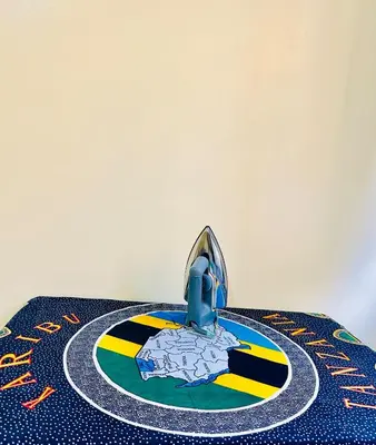 a table with a cake on top of a table at Cozy 1Bedroom Stand Alone -Near Clock Tower Arusha in Arusha