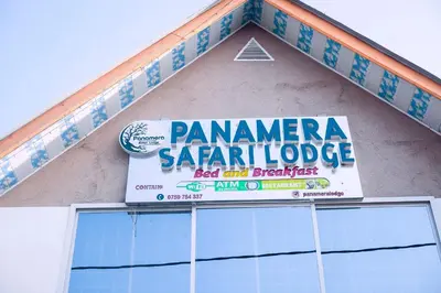 a sign on the side of a building at Panamera Safari Lodge in Boma la Ngombe