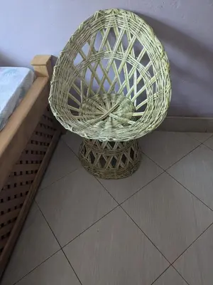 a basket sitting on the floor next to a bed at masai mama ecohostels in Arusha