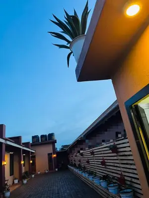 a building with a palm tree on top of it at Araess Homestay Karatu in Karatu