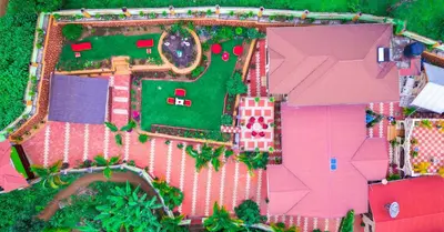 an overhead view of a pink house with a yard at Kilimanjaro Serenity Lodge & Camp