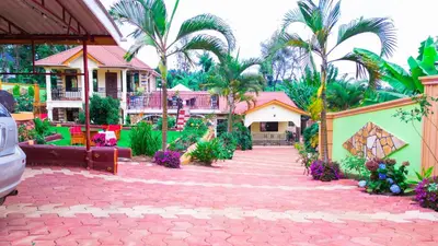 a house with palm trees and a red brick driveway at Kilimanjaro Serenity Lodge & Camp