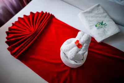 a red cloth with a red fan on a bed at Explora Lodge in Arusha
