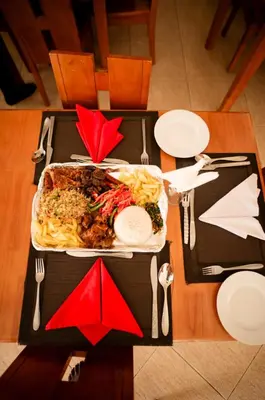 a table with a tray of food on a table at Explora Lodge in Arusha