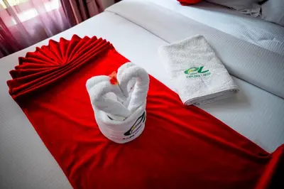 a swan robe and a towel on a bed at Explora Lodge in Arusha