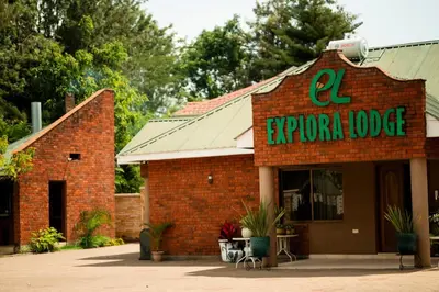 a red brick building with a sign on it at Explora Lodge in Arusha