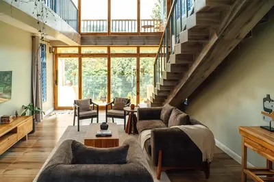 a living room with two couches and a staircase at Starico Residence in Nkoanrua