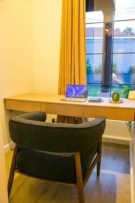 a chair sitting at a desk with a laptop at Modern Farmhouse & French Elegance Stay for 6 in Arusha