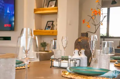 a table with wine glasses and a plate on it at Modern Farmhouse & French Elegance Stay for 6 in Arusha