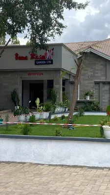 a front of a restaurant with a building at Boma masai garden in Boma la Ngombe