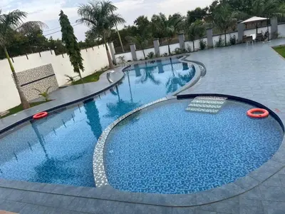 a large swimming pool with blue water at Boma masai garden in Boma la Ngombe