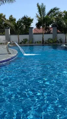 a pool with a water fountain in a resort at Boma masai garden in Boma la Ngombe