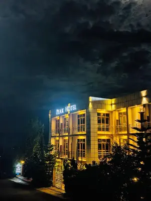 a building with a sign that reads tax hotel at night at Peak Hotel & Safaris in Karatu