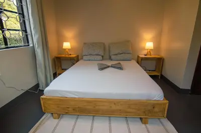 a bedroom with a bed with a bow tie on it at Open Gate House in Arusha