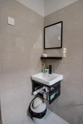 a bathroom with a sink and a mirror at Open Gate House in Arusha